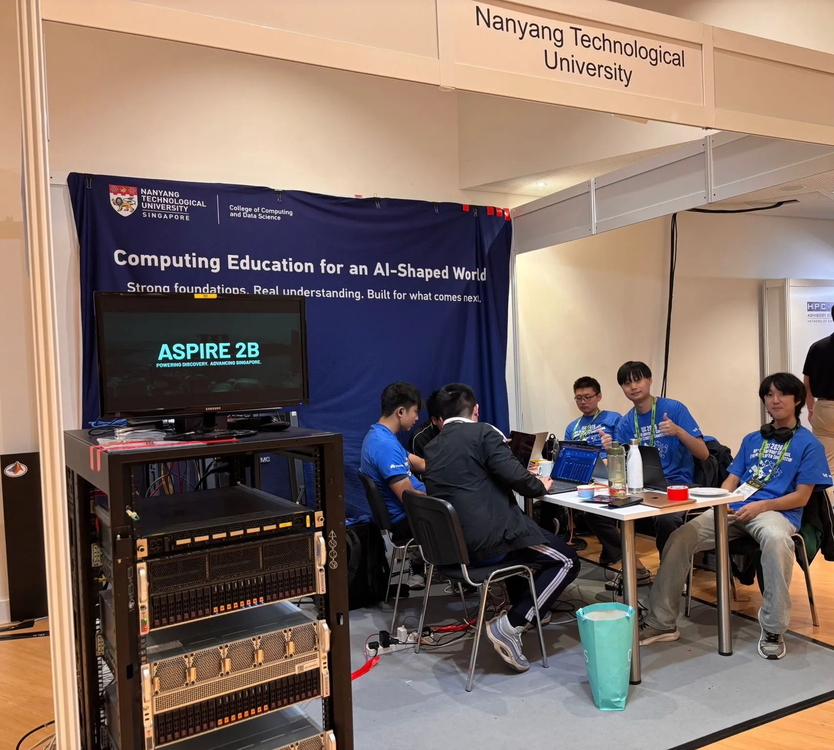 NTU HPC/AI members operating a student cluster at a competition booth