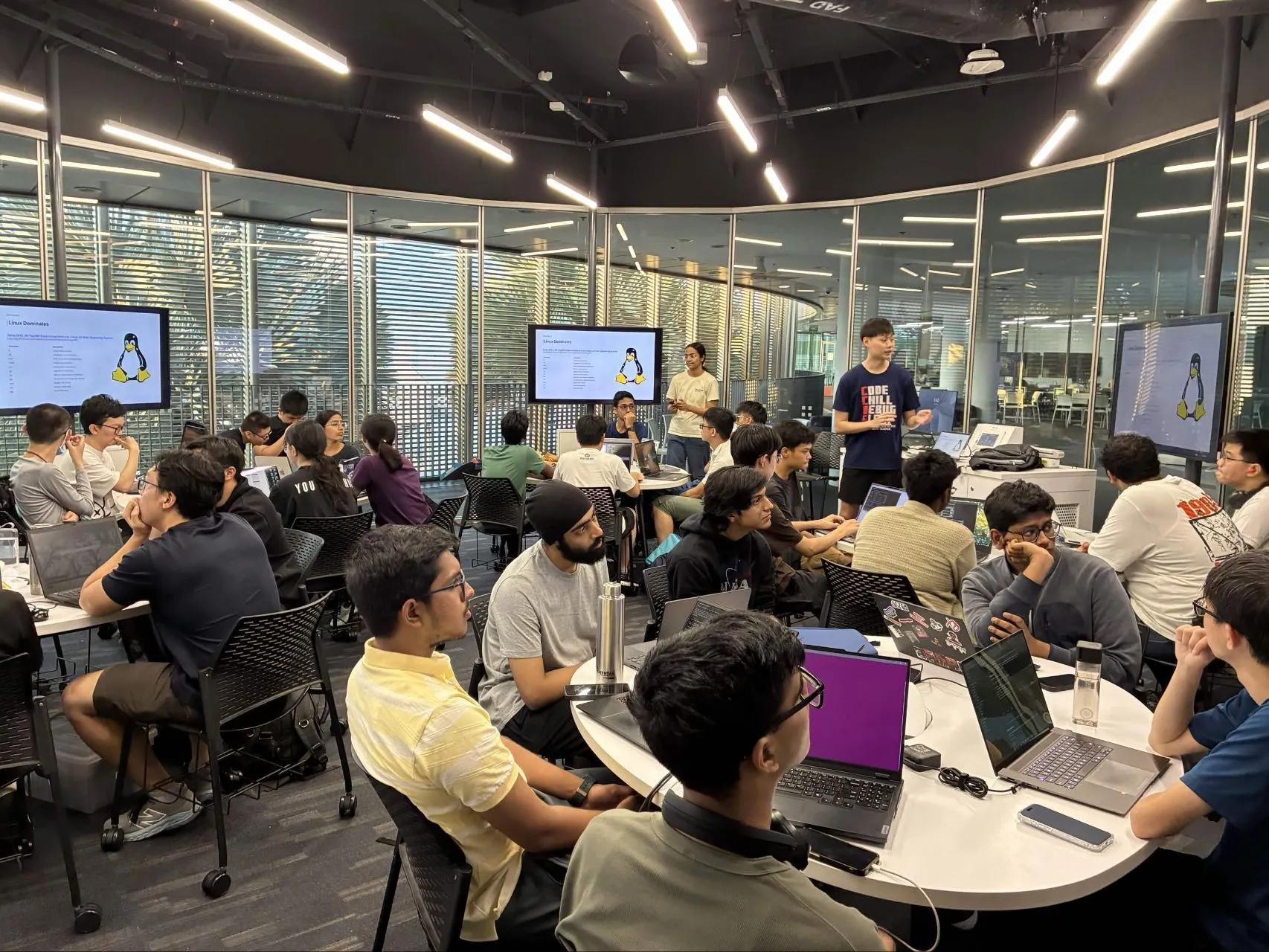 Participants working in groups during NTU HPC/AI's inaugural workshop at Innovation Lab @ NTU CCDS.