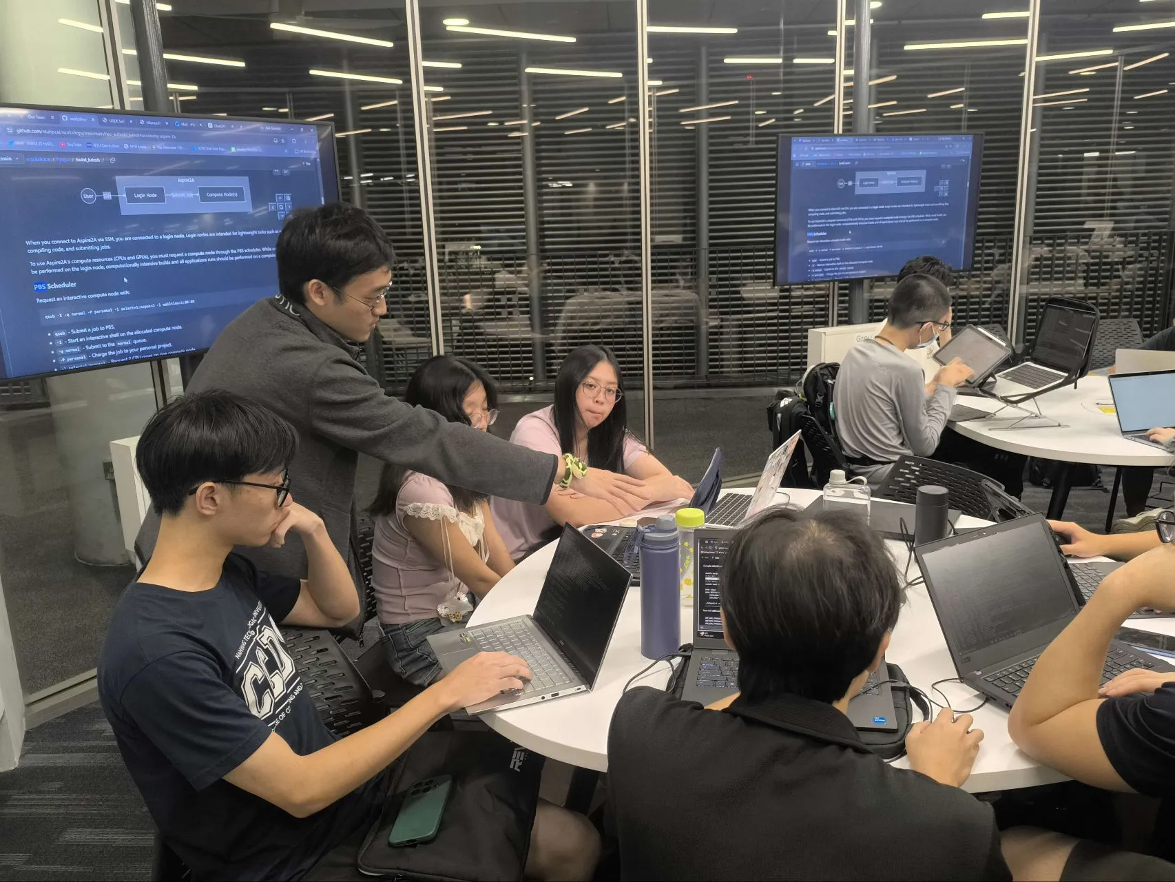 A workshop facilitator helping participants during the hands-on computing exercise.